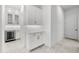 Butler's pantry with white cabinets, wine fridge, and marble countertops at 33736 Ocean Spray Ln, Wesley Chapel, FL 33543
