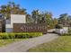 Landscaped entrance sign for the 'River's Edge' community with stone and wood details at 33736 Ocean Spray Ln, Wesley Chapel, FL 33543