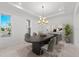 Elegant dining room with a large modern table and lots of natural light at 33736 Ocean Spray Ln, Wesley Chapel, FL 33543