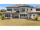 Beautiful two-story home with a covered patio and outdoor kitchen, overlooking the spacious backyard at 33736 Ocean Spray Ln, Wesley Chapel, FL 33543