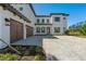 Beautiful exterior of a two-story home with paver driveway and a three-car garage at 33736 Ocean Spray Ln, Wesley Chapel, FL 33543