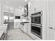 Elegant kitchen features stainless steel appliances, white cabinetry, and marble countertops at 33736 Ocean Spray Ln, Wesley Chapel, FL 33543