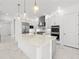 Modern kitchen with stainless steel appliances, a center island, and stylish pendant lighting at 33736 Ocean Spray Ln, Wesley Chapel, FL 33543