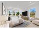 Relaxing primary bedroom with a view of the lake, ample natural light, and neutral decor at 33736 Ocean Spray Ln, Wesley Chapel, FL 33543