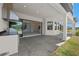 An outdoor kitchen and patio with view to interior through large sliding glass doors at 33736 Ocean Spray Ln, Wesley Chapel, FL 33543