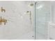 Luxurious marble shower with dual shower heads and glass enclosure at 33736 Ocean Spray Ln, Wesley Chapel, FL 33543