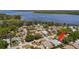 Aerial view of home in residential neighborhood near lake, with a red arrow pointing to property at 3948 Tarpon Pointe Cir, Palm Harbor, FL 34684