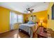 Bright bedroom featuring hardwood floors, a ceiling fan, and natural light at 3948 Tarpon Pointe Cir, Palm Harbor, FL 34684