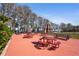 Outdoor community space featuring multiple picnic tables and umbrellas on a brick paved lot at 3948 Tarpon Pointe Cir, Palm Harbor, FL 34684
