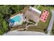Aerial view of community pool, lounge chairs, and recreation area with tables at 3948 Tarpon Pointe Cir, Palm Harbor, FL 34684