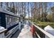 Picturesque view down a wooden dock towards the lake, with a pontoon boat tied to the dock at 3948 Tarpon Pointe Cir, Palm Harbor, FL 34684