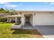 Charming home featuring an attached two-car garage and arched entrance with brick accents at 3948 Tarpon Pointe Cir, Palm Harbor, FL 34684