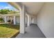 Welcoming front porch with brick pillars, offering a shaded entrance to the home at 3948 Tarpon Pointe Cir, Palm Harbor, FL 34684