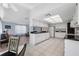Bright kitchen features white cabinets, appliances, and a view into the home's living area at 3948 Tarpon Pointe Cir, Palm Harbor, FL 34684