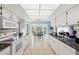 Well lit kitchen includes white appliances and views of the outside dining area through a pass through at 3948 Tarpon Pointe Cir, Palm Harbor, FL 34684