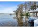 Beautiful lakeside view with a pontoon boat, offering serene waterfront living at 3948 Tarpon Pointe Cir, Palm Harbor, FL 34684