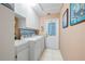 Well-equipped laundry room featuring washer, dryer, and ample storage cabinets at 3948 Tarpon Pointe Cir, Palm Harbor, FL 34684