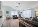 Bright and airy living room is equipped with wood flooring, stylish decor, and comfortable seating at 3948 Tarpon Pointe Cir, Palm Harbor, FL 34684