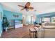 Cozy living area featuring a ceiling fan, modern flooring, beachy decor and comfortable sofa at 3948 Tarpon Pointe Cir, Palm Harbor, FL 34684