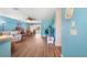 Open-concept living room featuring modern floors, bright blue walls, and comfortable seating at 3948 Tarpon Pointe Cir, Palm Harbor, FL 34684