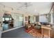 Bright sunroom with seating area and view of the living room at 3948 Tarpon Pointe Cir, Palm Harbor, FL 34684