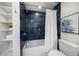 Bathroom with a tiled shower, white curtain, and organized shelving at 4036 Church Creek Pt, Largo, FL 33774