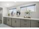 Bathroom features a long vanity with double sinks and stylish gray cabinetry at 4036 Church Creek Pt, Largo, FL 33774
