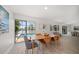 Charming dining room with seating for six and sliding glass doors to pool and waterway views at 4036 Church Creek Pt, Largo, FL 33774