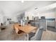 Open-concept kitchen and dining area, featuring a stylish kitchen island, dining table, and lots of light at 4036 Church Creek Pt, Largo, FL 33774