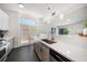 Bright, updated kitchen with gray cabinets, white counters, and views to the outdoors at 4036 Church Creek Pt, Largo, FL 33774