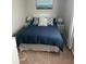 Comfortable bedroom with carpet, featuring a bed with lamps, and window at 4201 La Palma Ct, Tampa, FL 33611