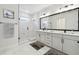 Sleek and spacious bathroom with double vanity, large mirror, glass shower, and elegant marble tiling at 5011 21St N Ave, St Petersburg, FL 33710