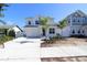 Charming two-story home featuring a well-manicured front yard, a wide driveway, and inviting curb appeal at 5011 21St N Ave, St Petersburg, FL 33710