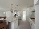 Open-concept kitchen with white cabinets, granite countertops and decorative pendant lighting at 5011 21St N Ave, St Petersburg, FL 33710