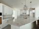 Bright kitchen with white cabinets, granite countertops and elegant pendant lighting at 5011 21St N Ave, St Petersburg, FL 33710