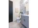 Chic powder room featuring a gray vanity, gold fixtures, and decorative blue tile backsplash at 526 39Th S Ave, St Petersburg, FL 33705