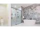 Bathroom featuring a glass-enclosed shower and a stand-alone tub at 526 39Th S Ave, St Petersburg, FL 33705