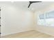 Bright bedroom with a large window, neutral walls, light-colored flooring, and modern ceiling fan at 526 39Th S Ave, St Petersburg, FL 33705