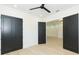 Open bedroom with neutral walls, three doors, ceiling fan, and wood-look flooring at 526 39Th S Ave, St Petersburg, FL 33705