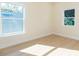 Bright bedroom with two windows, light wood flooring, and neutral paint at 526 39Th S Ave, St Petersburg, FL 33705