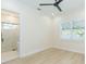 Bedroom with bright window and view into bathroom featuring a glass shower door at 526 39Th S Ave, St Petersburg, FL 33705