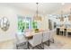 Elegant dining area with modern lighting, backyard views, and an open flow to the kitchen at 526 39Th S Ave, St Petersburg, FL 33705