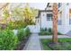Landscaped side yard with a paver walkway, mature trees, and a white fence with a gate at 526 39Th S Ave, St Petersburg, FL 33705