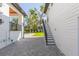 Backyard view showing paved area, stairs to elevated outdoor area and a partial view of the pool at 526 39Th S Ave, St Petersburg, FL 33705