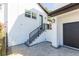 Exterior with a stairway leading up to a second-story entrance and a black garage door at 526 39Th S Ave, St Petersburg, FL 33705