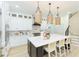 This gourmet kitchen features white cabinets, black island, and stainless steel appliances at 526 39Th S Ave, St Petersburg, FL 33705