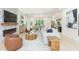 Bright, open-concept living room featuring a modern fireplace, stylish furnishings, and an adjacent dining area at 526 39Th S Ave, St Petersburg, FL 33705