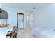 A compact room with a bed, built-in washer/dryer closet, desk and bright window at 527 S Lincoln Ave # A108, Tampa, FL 33609