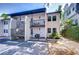 Two-story condo building with parking area and exterior stairs and balcony on a sunny day at 527 S Lincoln Ave # A108, Tampa, FL 33609