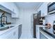 Modern kitchen featuring sleek white cabinets, stainless steel appliances, and ample counter space at 527 S Lincoln Ave # A108, Tampa, FL 33609